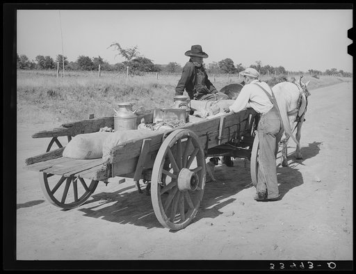 Farmer's wagon loaded with supplies leaving crossroads store in McIntosh County, Oklahoma