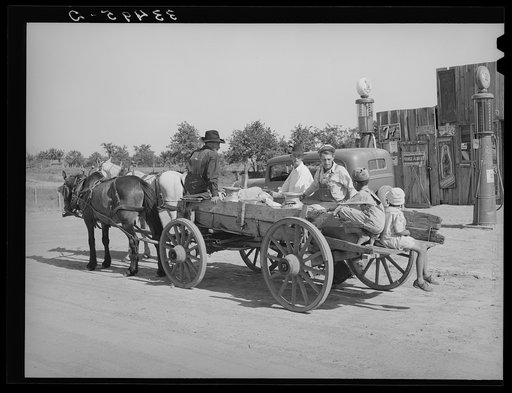Farmer's wagon loaded with supplies leaving crossroads store in McIntosh County, Oklahoma