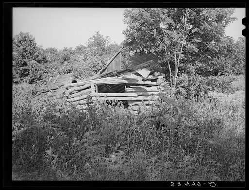 Abandoned shed and plow. Former farmstead in McIntosh County, Oklahoma