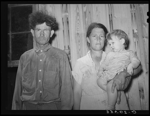 Agricultural day laborer, former oil field worker and miner, with his wife and baby. McIntosh County, Oklahoma. He said "I hope the next time you see me you'll find me in better condition."