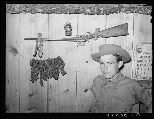 Son of agricultural day laborer with his twenty-two caliber rifle and home-cured tobacco. McIntosh County, Oklahoma