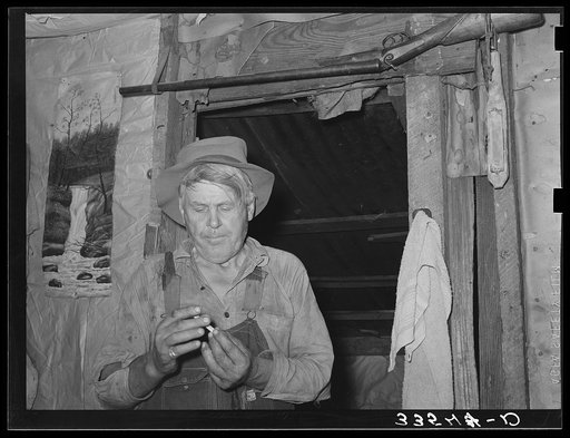 Agricultural day laborer in his home near Tullahassee, Oklahoma. Wagoner County