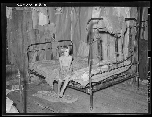 Daughter of agricultural day laborer in bedroom of home in McIntosh County, Oklahoma