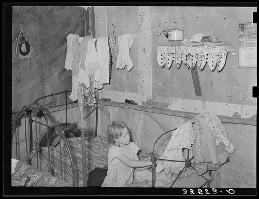 Interior of combined bedroom and living room of agricultural day laborer near Tullahassee, Oklahoma. Wagoner County