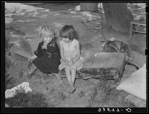 Children of agricultural day laborer sitting on an old automobile seat cushion. On Poteau Creek near Spiro, Oklahoma, Sequoyah County