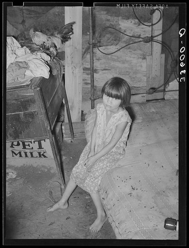 Daughter of agricultural day laborer and his tubercular wife in bedroom of shack home on Poteau Creek near Spiro, Oklahoma