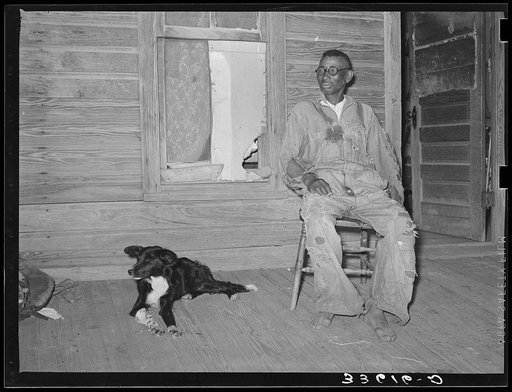 Old Negro and his dog. He is a tenant farmer living in Wagoner County, Oklahoma