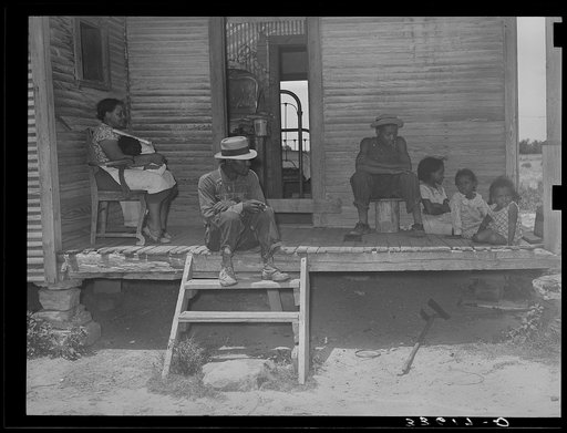 Untitled photo, possibly related to: Negro tenant farmer and his family on front porch of their home in Wagoner County, Oklahoma