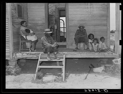 Negro tenant farmer and his family on front porch of their home in Wagoner County, Oklahoma