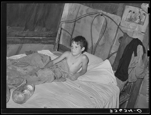 Young son of agricultural day laborer in bed. Near Vian, Oklahoma, Sequoyah County