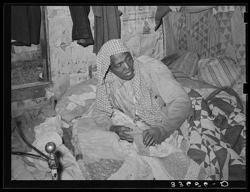 Old Negress, wife of agricultural day laborer, in bed with rheumatism. Wagoner County, Oklahoma