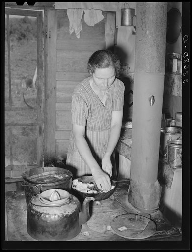 Wife of farmer now on WPA (Works Progress Administration/Work Projects Administration) roadwork making blackberry pie. Near Sallisaw, Oklahoma
