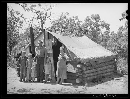 Family who have small goat dairy in front of their tent home near Sallisaw, Oklahoma. They had moved into the tent to save rent and fuel money in town