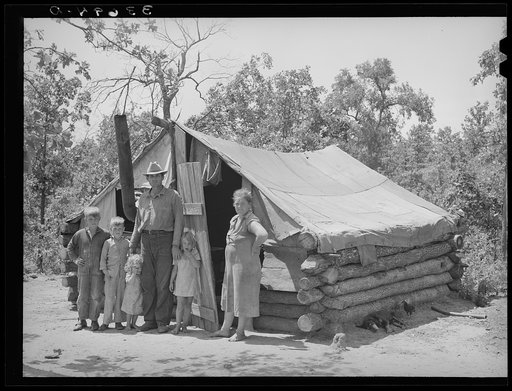 Untitled photo, possibly related to: Family who have small goat dairy in front of their tent home near Sallisaw, Oklahoma. They had moved into the tent to save rent and fuel money in town