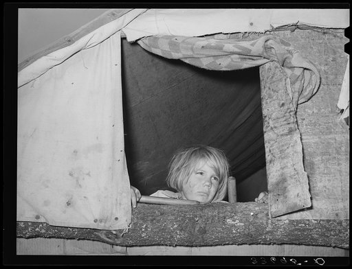 Child looking out of window of tent home near Sallisaw, Oklahoma. Sequoyah County