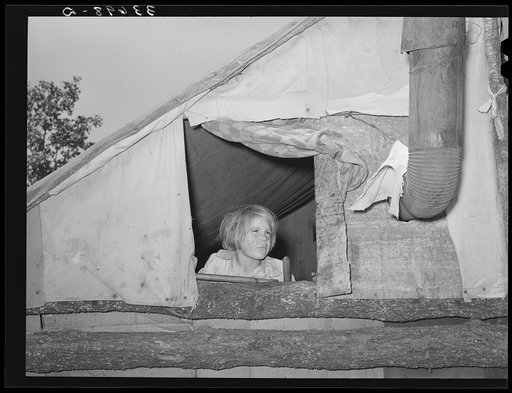 Child looking out of window of tent home near Sallisaw, Oklahoma. Sequoyah County