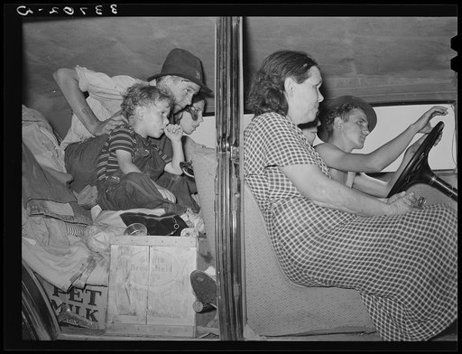 Migrants packed into their automobile near Muskogee, Oklahoma. Muskogee County