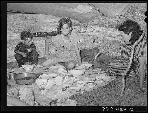 Migrant agricultural workers eating noonday meal near Muskogee, Oklahoma. Muskogee County