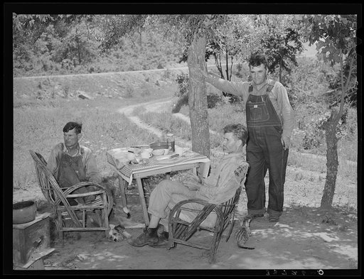 Farmers visiting an old couple living in tent outside of Sallisaw, Oklahoma. Sequoyah County