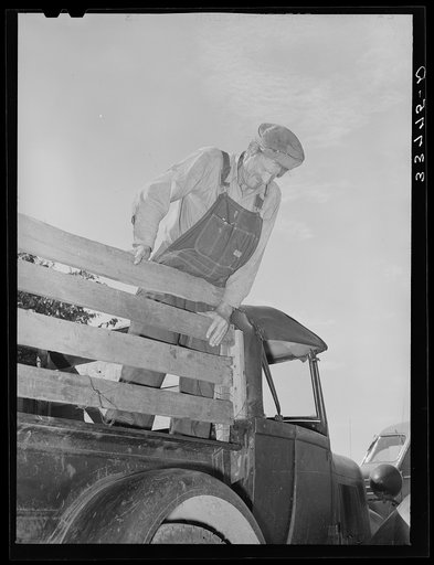 Elmer Thomas, migrant to California, standing on the body of his improvised truck before leaving for California. Near Muskogee, Oklahoma