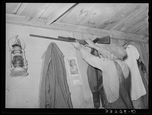 Moving the rifle which was placed on the wall before leaving for California from Muskogee, Oklahoma
