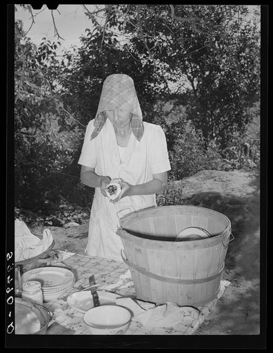 Untitled photo, possibly related to: Packing dishes and silverware preparatory to departure for California from Muskogee, Oklahoma