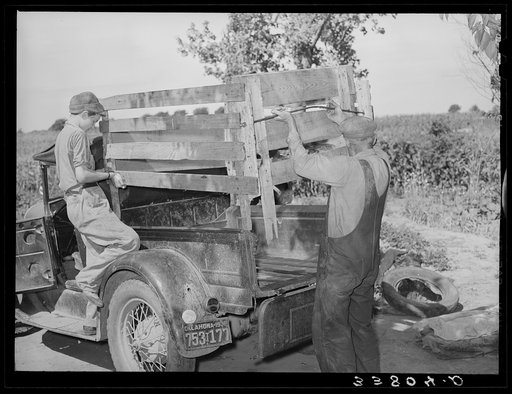 Getting ready to leave for California. Putting the cage in place on rear of truck. Near Muskogee, Oklahoma
