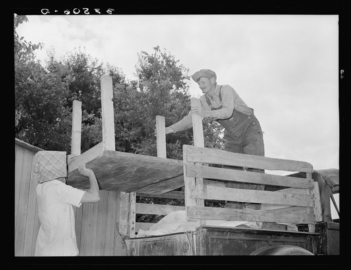 Loading table onto truck. Migrant family leaving from Muskogee enroute to California. Oklahoma