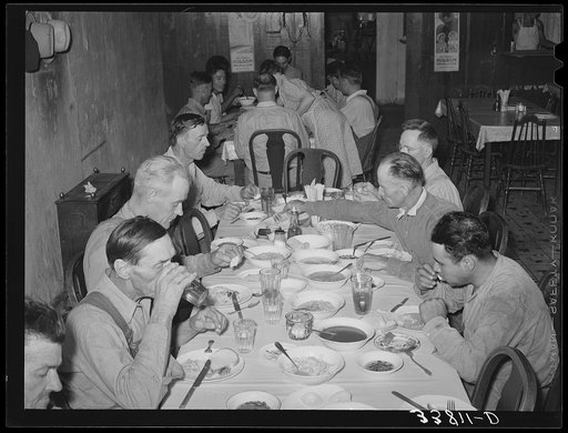 Noonday dinner, family-style, at restaurant in Muskogee, Oklahoma. The price of this dinner was fifteen cents. It included a medium-sized serving of meat, sliced tomatoes, beans, corn on the cob, potatoes, dumplings, corn bread and butter, tea and coffee, various jellies and preserves and onions. Al