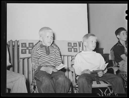 Children singing at boys' camp fireside meeting. El Porvenir, New Mexico