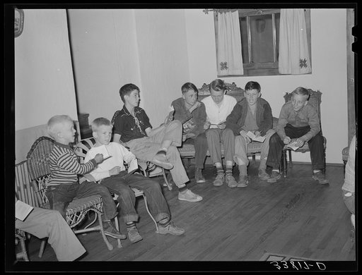 Children singing at boys' camp fireside meeting. El Porvenir, New Mexico