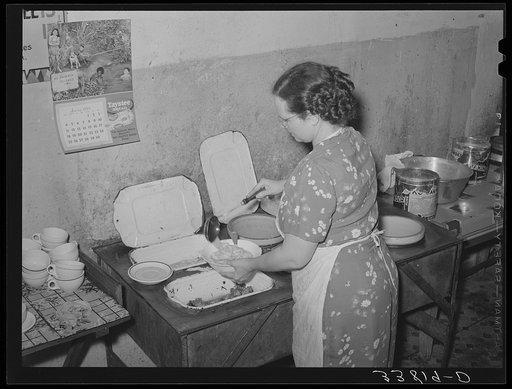 Proprietress of family style restaurant dishing up food. Muskogee, Oklahoma