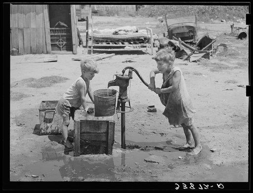 Children of Mays Avenue camp pumping water from thirty-foot well which supplies about a dozen families. Oklahoma City, Oklahoma. Refer to general caption 21