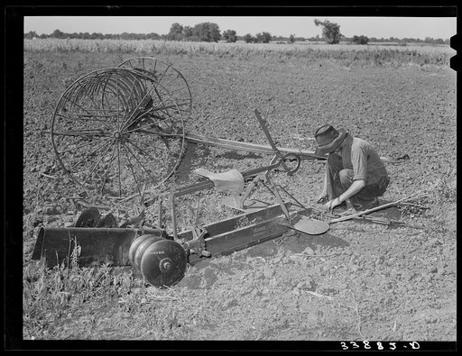 Son of tenant farmer near Muskogee, Oklahoma, working on disc harrow with rake in background. Refer to general caption no. 20