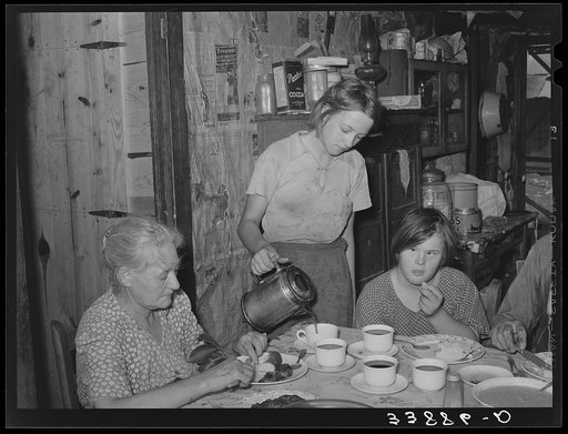 Daughter of tenant farmer pouring coffee at noonday meal. Near Muskogee, Oklahoma. See general caption number 20