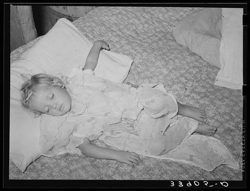 Daughter of water peddler in community camp, Oklahoma City, Oklahoma, asleep. She is covered with old curtain to protect her from flies. See general caption no. 21