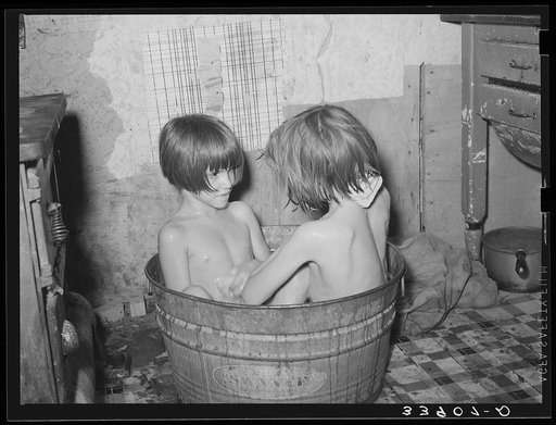 Untitled photo, possibly related to: Children taking bath in their home in community camp. Oklahoma City, Oklahoma. See general caption 21