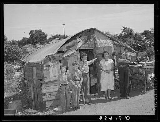 Family in front of shack home near Mays Avenue camp. Oklahoma City, Oklahoma. He had farmed near Norman, Oklahoma, until a year previously. See general caption no. 21