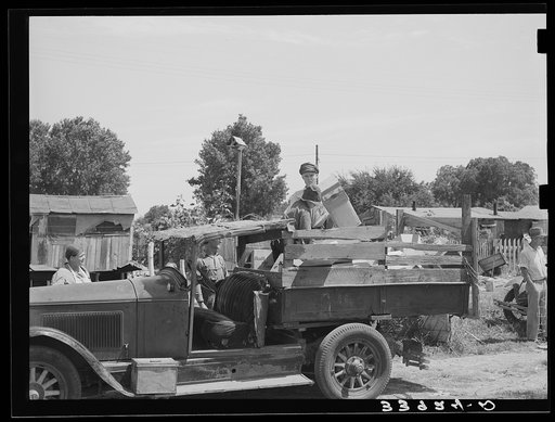 Unloading boxes from truck at shack home near Mays Avenue camp. Oklahoma City, Oklahoma. See general caption no. 21