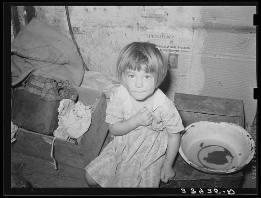 Little girl in shack home in camp near Mays Avenue. Oklahoma City, Oklahoma. See general caption no. 21