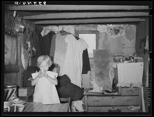 Interior of shack home, Mays Avenue camp. Little girl is daughter of former farmer. Oklahoma City, Oklahoma