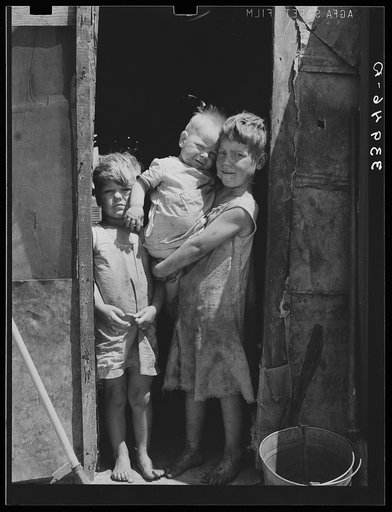 Untitled photo, possibly related to: Children of Mays Avenue camp dressed in old sacks. Their father is a "trasher." Oklahoma City, Oklahoma