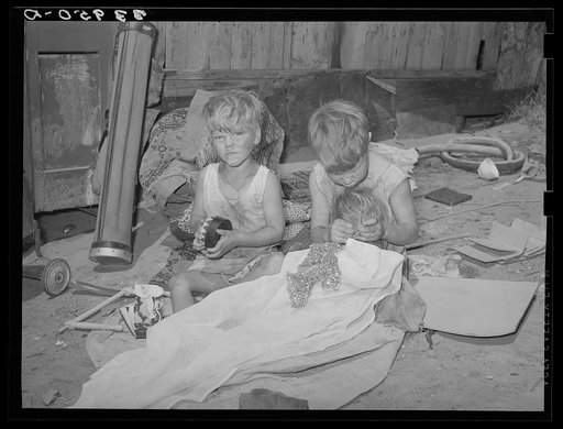 Untitled photo, possibly related to: Children of Mays Avenue camp. Oklahoma City, Oklahoma. Their father is a trasher and they are playing with some things he picked up. See general caption no. 21