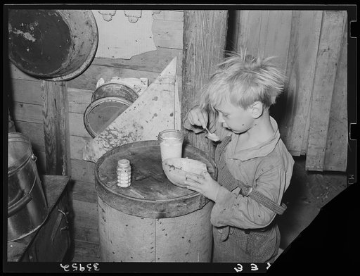 Child in Mays Avenue camp, Oklahoma City, Oklahoma, eating an overripe canteloupe found in market. See general caption 21