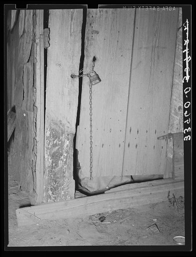 Locked door of shack. Mays Avenue camp, Oklahoma City, Oklahoma. The sense of possession is just as strong in this downtrodden group as in any other. See general caption no. 21