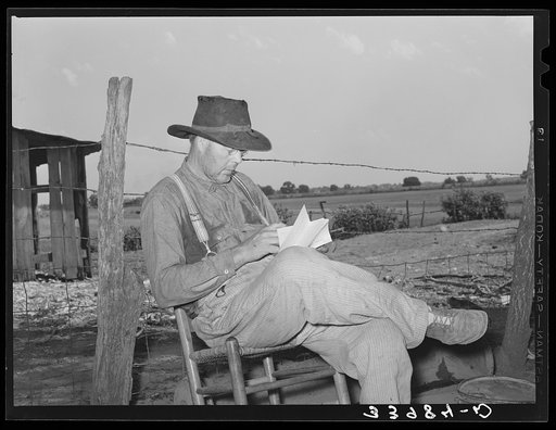 Tenant farmer looking through the mail. Near Muskogee, Oklahoma. See general caption 20