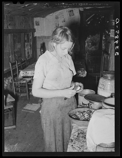Daughter of tenant farmer peeling potatoes for noonday meal. Muskogee, Oklahoma