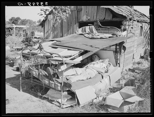Bed with roof over it in Mays Avenue camp. Oklahoma City, Oklahoma. See general caption 21