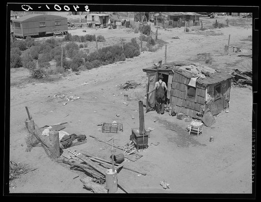 Shack home and yard. Mays Avenue camp, Oklahoma City, Oklahoma. Notice crude fence made of old water boilers and discarded fencing. See general caption no. 21