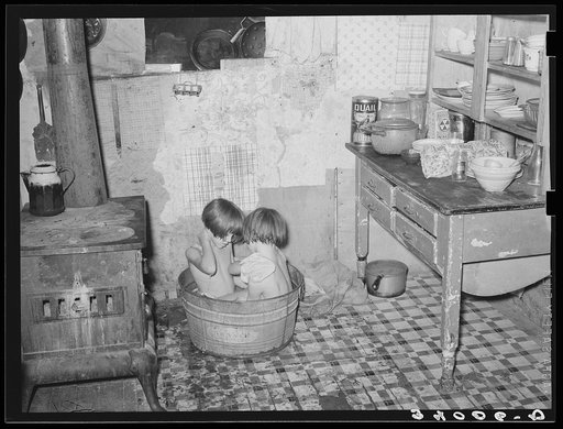 Children taking bath in their home in community camp. Oklahoma City, Oklahoma. See general caption 21